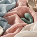 Sea-green vibrator on folded pale blue, pink and white fabric